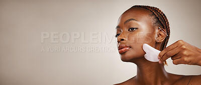 Buy stock photo Skincare, black woman or gua sha on face for beauty, acne or blood circulation in studio on brown background. Cosmetic, person and facial product for lymphatic drainage, wellness and mock up for skin