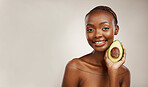 Avocado, beauty and portrait of woman in studio for detox, mockup space and brown background. Face of happy african model, natural skincare and fruit for vegan cosmetics, sustainable diet or benefits