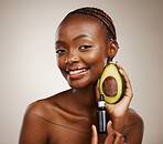 Black woman, portrait and avocado oil with product, natural beauty and skincare with vegan cosmetics on brown background. Smile for dermatology, bottle with vegetable for liquid or serum in studio