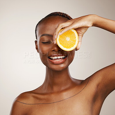 Buy stock photo Black woman, orange fruits and beauty in studio for vitamin c, vegan cosmetics and facial on brown background. Happy model, citrus and nutrition for natural skincare, organic benefits and detox diet 