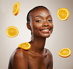 Black woman, portrait and skincare with orange, fruit and natural vitamin c benefit in beauty or studio background. Citrus, cosmetics and face with glow, shine or wellness from dermatology or facial