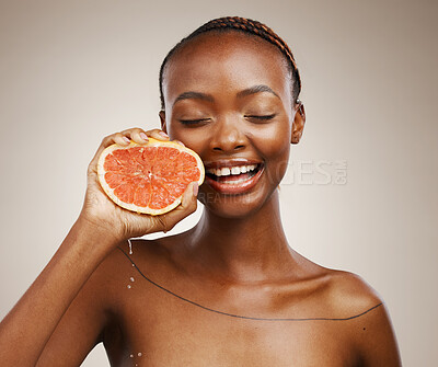 Buy stock photo Portrait, smile or happy black woman with grapefruit for skincare or beauty in studio on brown background. Results, dermatology or African person with natural fruits, vitamin c or glow for wellness 