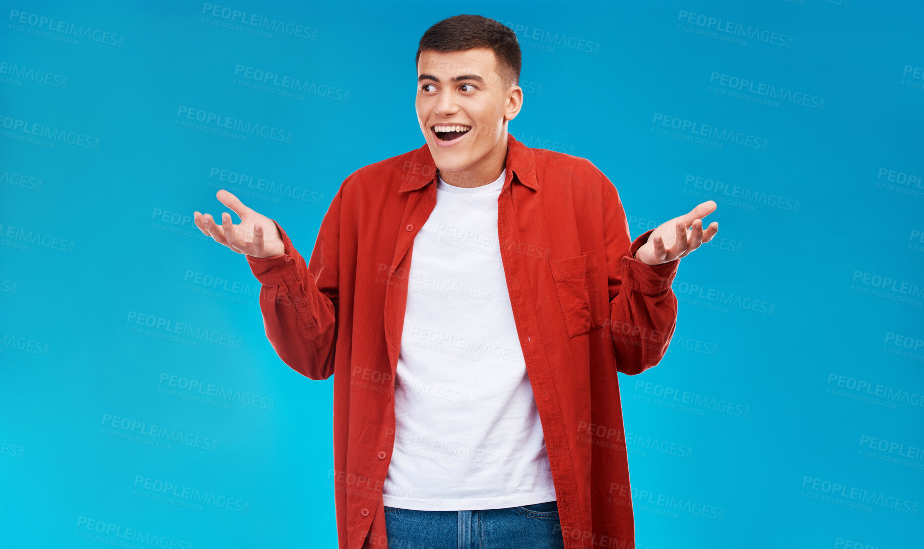 Buy stock photo Confused, shrug and young man in a studio with options, decision or comparison expression. Shock, balance and male model from Canada with doubt hand gesture isolated by blue background with mockup.