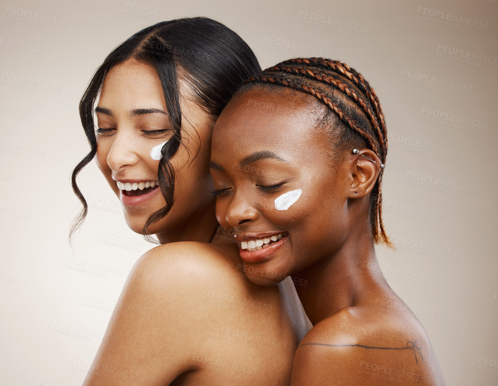 Buy stock photo Women, lotion on face and beauty with diversity, friends and inclusive skincare on studio background. Dermatology, natural cosmetics and happiness for wellness, cream and skin glow with moisturizer
