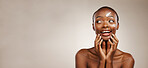 Beauty, smile and black woman with skincare, cream and wellness on a grey studio background. African person, girl or model with creme, aesthetic or cosmetics with happiness, mockup space or self care