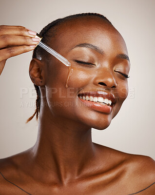 Buy stock photo Skincare, woman and smile with dropper on studio background for wellness in cosmetics, beauty or serum. African, person or model by happy, face or relaxed for facial treatment for anti aging oil