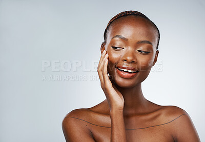 Buy stock photo Face, skincare and hand on the cheek of a black woman in studio on a gray background for beauty or natural wellness. Space, mockup or banner and a young model with luxury cosmetic skin treatment