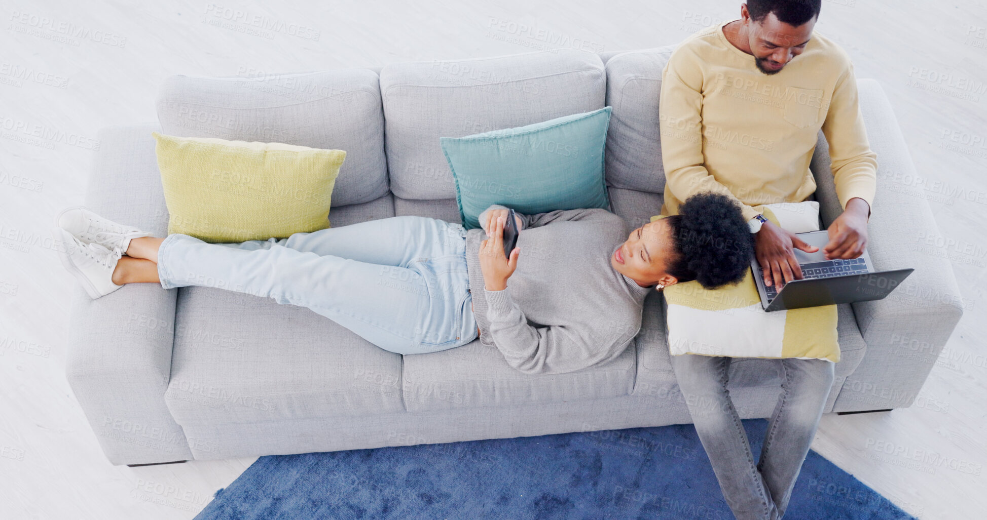 Buy stock photo Top view, home and couple with a smartphone, laptop and relaxing with connection, network and search internet. Apartment, man and woman on a couch, cellphone and pc with website information and relax