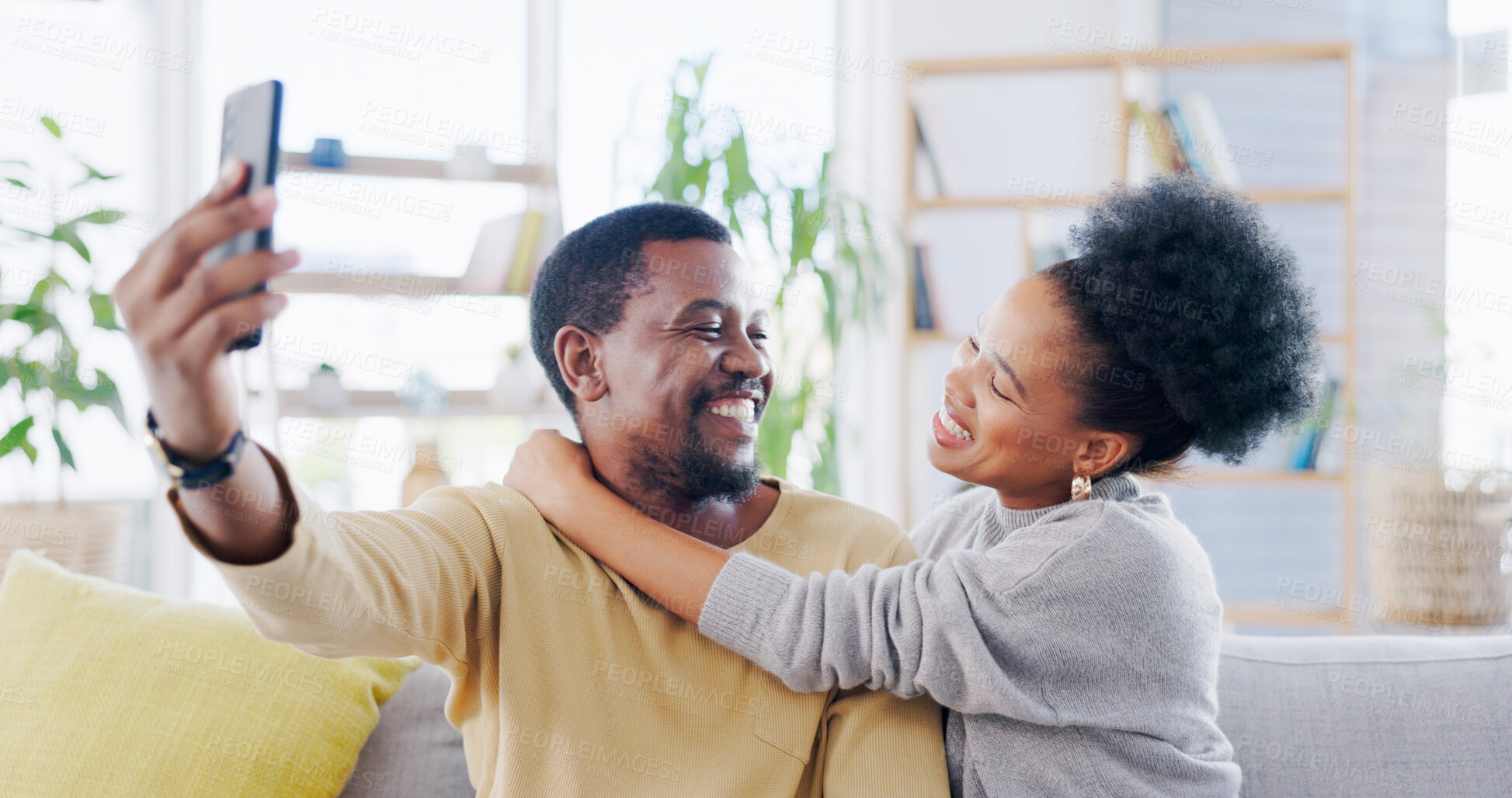 Buy stock photo Happy African couple, selfie and sofa with hug, smile and post on web blog, love and bonding in home. Black woman, man and memory with photography, profile picture or romance on social media on house