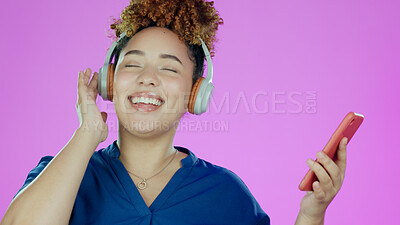 Buy stock photo Headphones, dance and woman with phone in studio listening to song, audio and radio. Happy, music and face of person with smartphone for streaming subscription, relax and fun on purple background