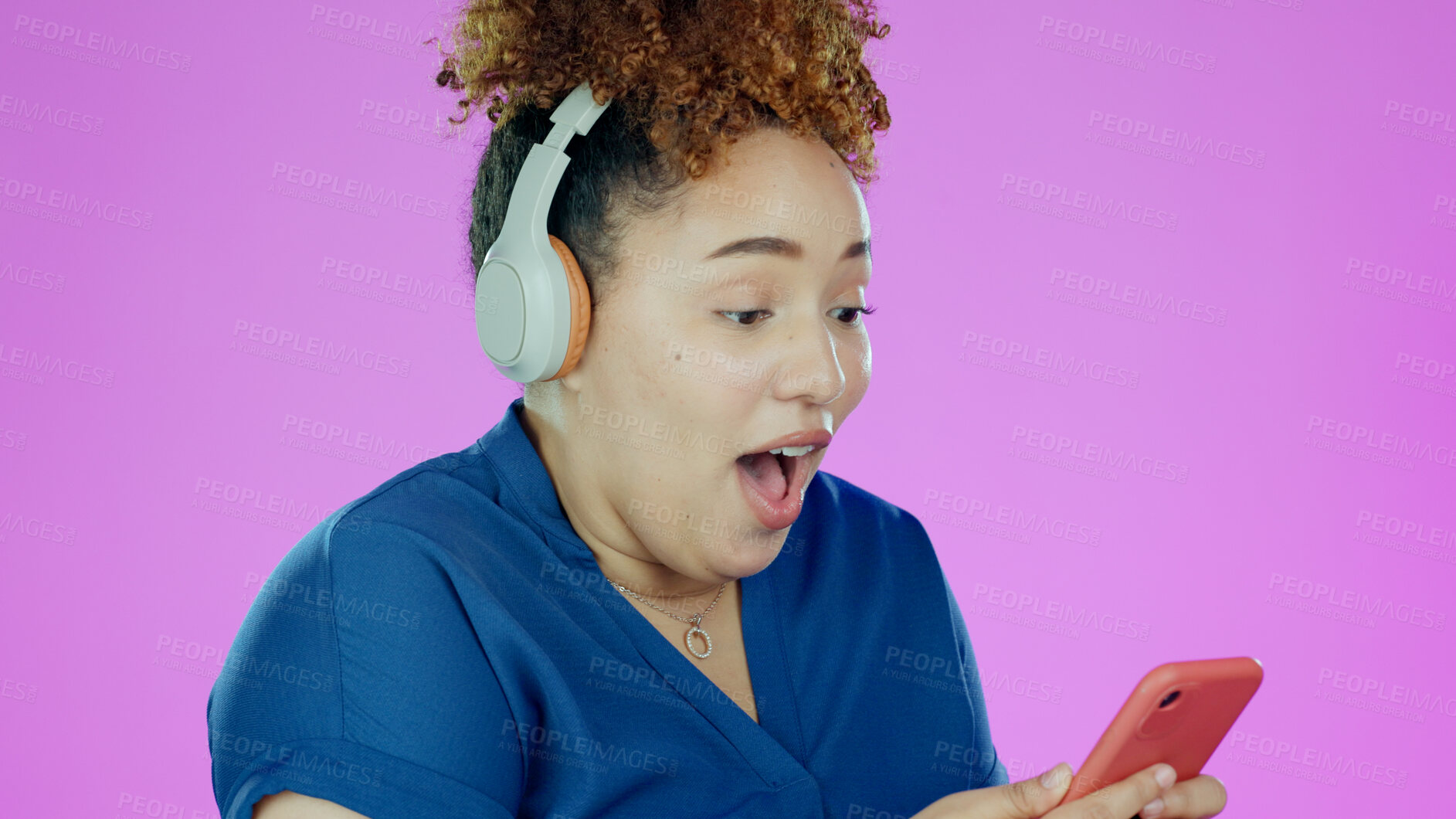 Buy stock photo Woman, phone and wow with headphones for winner, promotion or announcement in studio on purple background. Smartphone, person and surprised for notification, sale and lottery news with mock up space