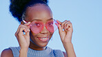 Portrait, fashion and black woman with glasses, funky and confident girl on a blue background. Face, African person and model with trendy eyewear, hipster and gen z with style, vision and aesthetic