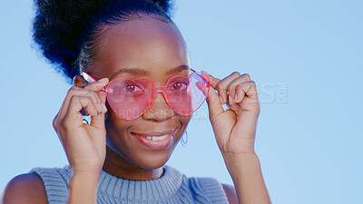 Buy stock photo Portrait, fashion and black woman with glasses, funky and confident girl on a blue background. Face, African person and model with trendy eyewear, hipster and gen z with style, vision and aesthetic