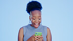 Shock, phone and black woman in a studio with good news on the internet for winning a bet. Happy, surprise and excited young African female model scroll on cellphone isolated by blue background.
