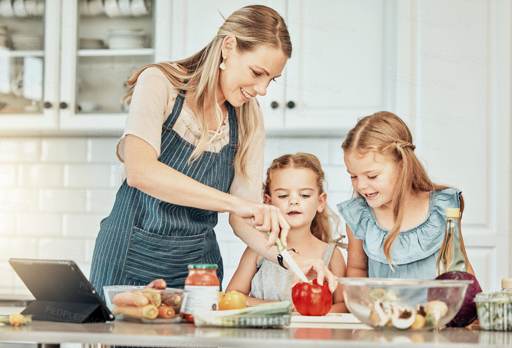 Buy stock photo Happy woman in kitchen, cooking together with kids and teaching, learning and nutrition with tablet. Online recipe, mam and girl children help making healthy food in home with care, support and love.