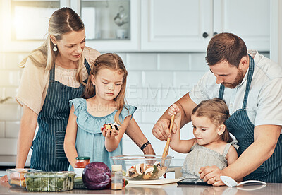 Buy stock photo Family, kitchen and cooking food with love, salad and nutrition for dinner, home and bonding. Happy parents and children, help and support in healthy ingredients and diet, together and care for lunch