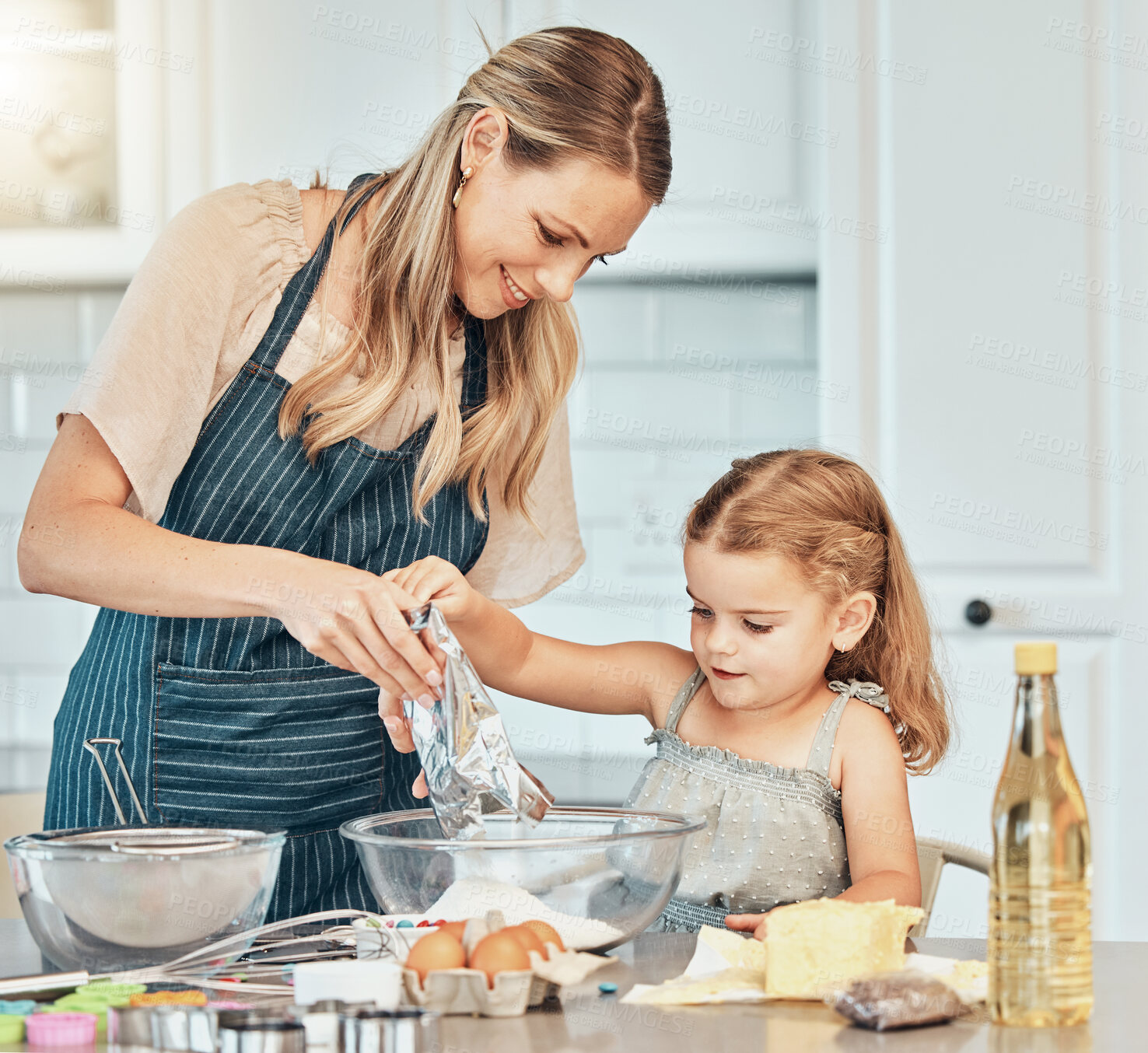 Buy stock photo Mom, girl kid and teaching for cooking, development and skills with bonding, love and care in family home. Baking, mother and daughter with bowl, flour and eggs on table, kitchen and helping for food