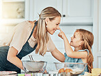 Playful mom in kitchen, baking together with kid and happy learning, nutrition and morning with woman. Smile, mother and girl child, cooking or playing in home with care, support or love at breakfast