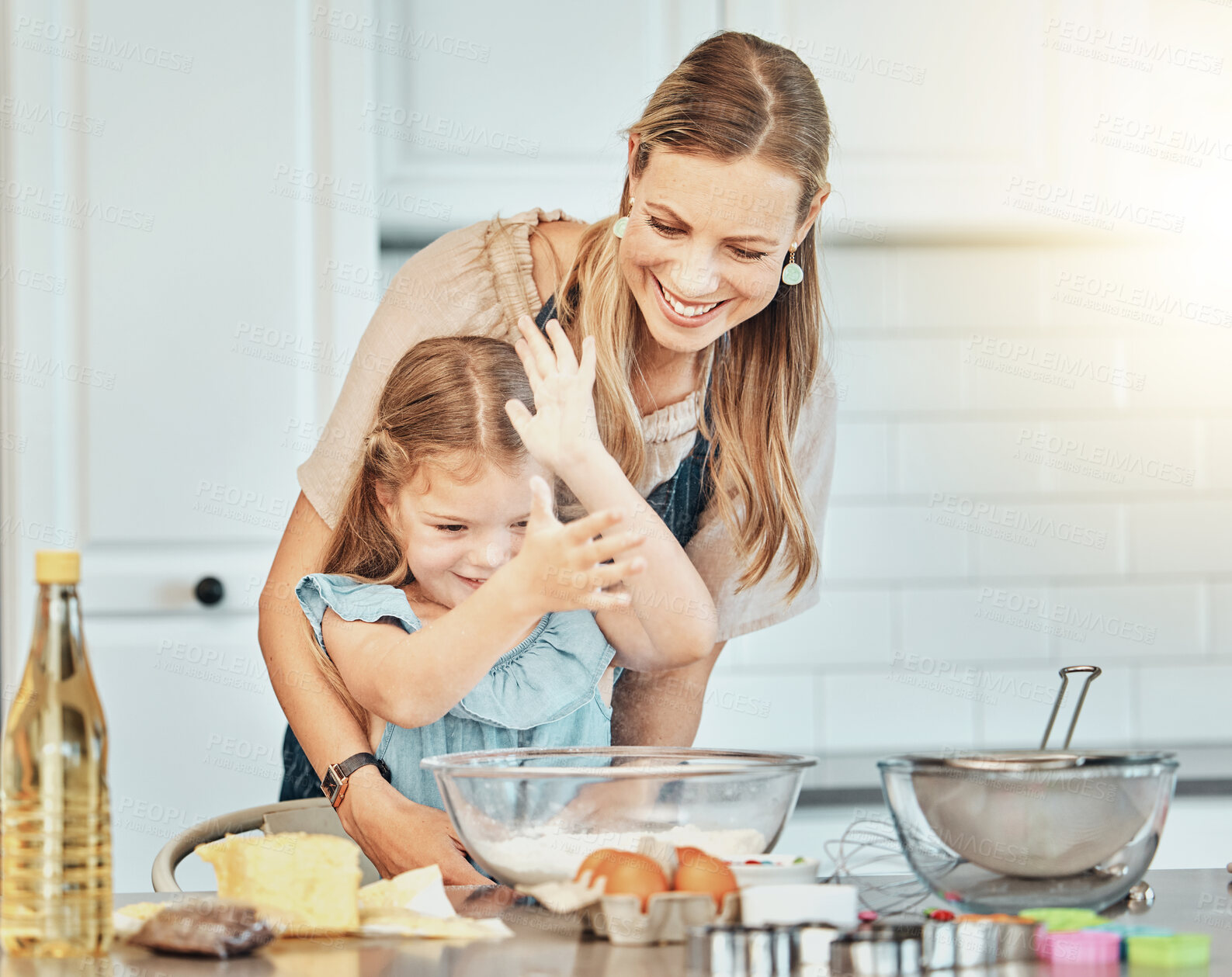 Buy stock photo Mom, girl child and flour in kitchen, development and baking with bonding, love and care in family house. Cooking, mother and daughter with smile, teaching and eggs on table, dust and help for food