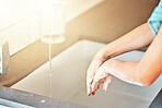 Soap, washing hands and kid with water for cleaning, hygiene and wellness in bathroom at home. Health, child development and palms of young girl with foam for protection for germs, virus and bacteria