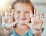 Soap, washing hands and kid with foam for cleaning, hygiene and wellness in bathroom at home. Health, child development and palms of young girl with water for protection for germs, virus and bacteria