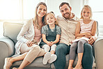 Happy, love and portrait of family on a sofa in the living room bonding and relaxing together at home. Happiness, Smile and girl children laying with parents from Australia on floor in the lounge.