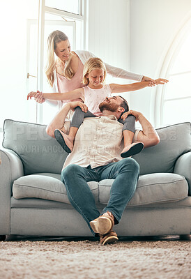 Buy stock photo Parents, kid and airplane on sofa, smile and playful for love, care or bonding in living room at family home. Father, mother and daughter with plane game, excited or together on lounge couch in house