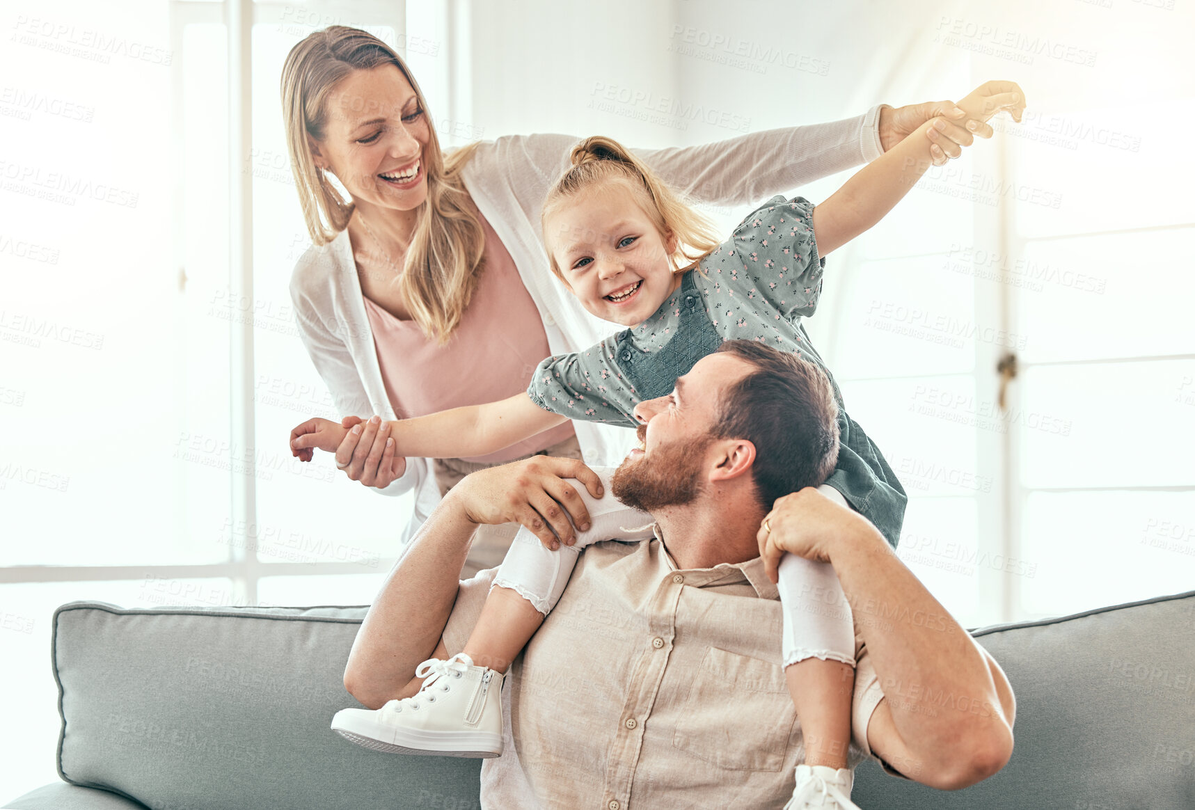 Buy stock photo Airplane, fantasy and parents playing with child on a couch in a home together and bonding as a family with love. Care, happiness and kid happy with mother and father on a sofa for fun 