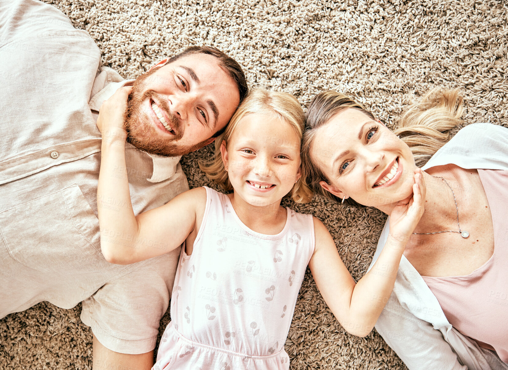 Buy stock photo Happy, portrait and child with parents in the living room bonding and relaxing together at home. Happiness, love and girl kid laying with mother and father from Australia on floor in lounge at house.