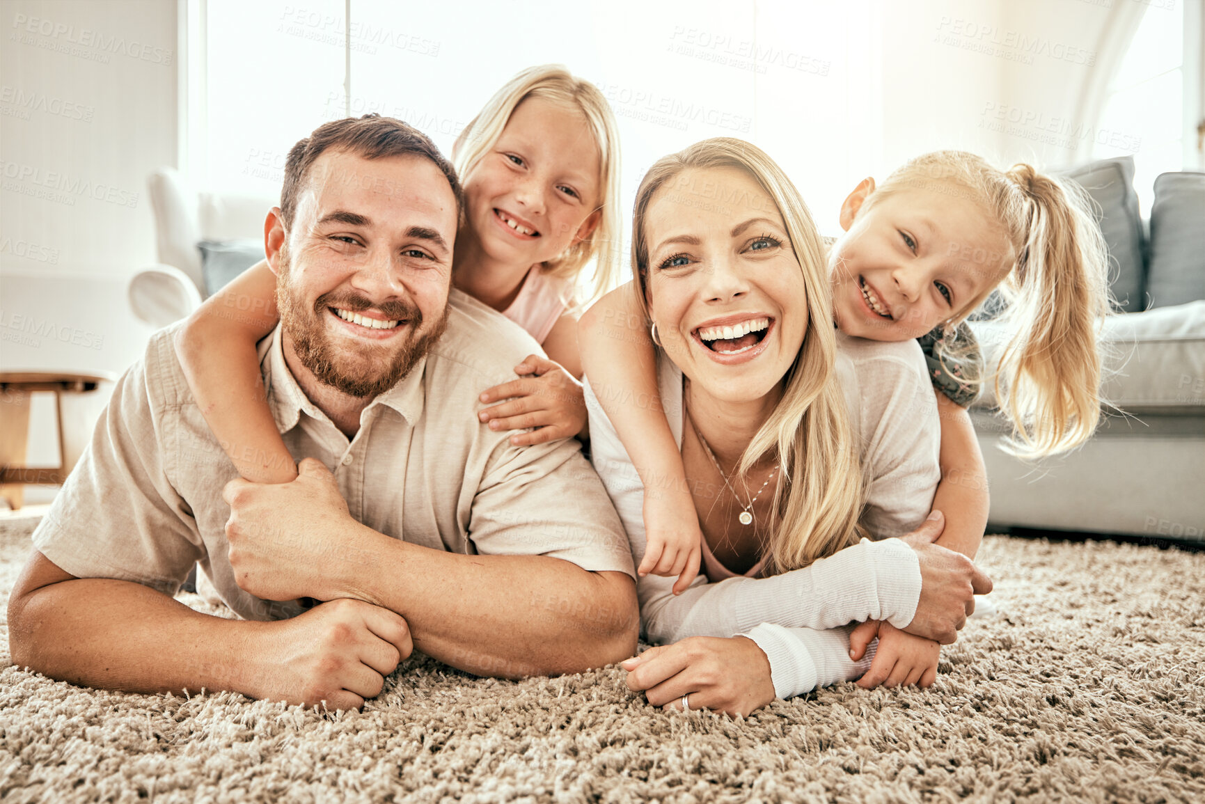 Buy stock photo Happy, smile and portrait of family in the living room bonding, hugging and relaxing together. Happiness, love and girl children laying with parents from Australia on floor in lounge at modern home.