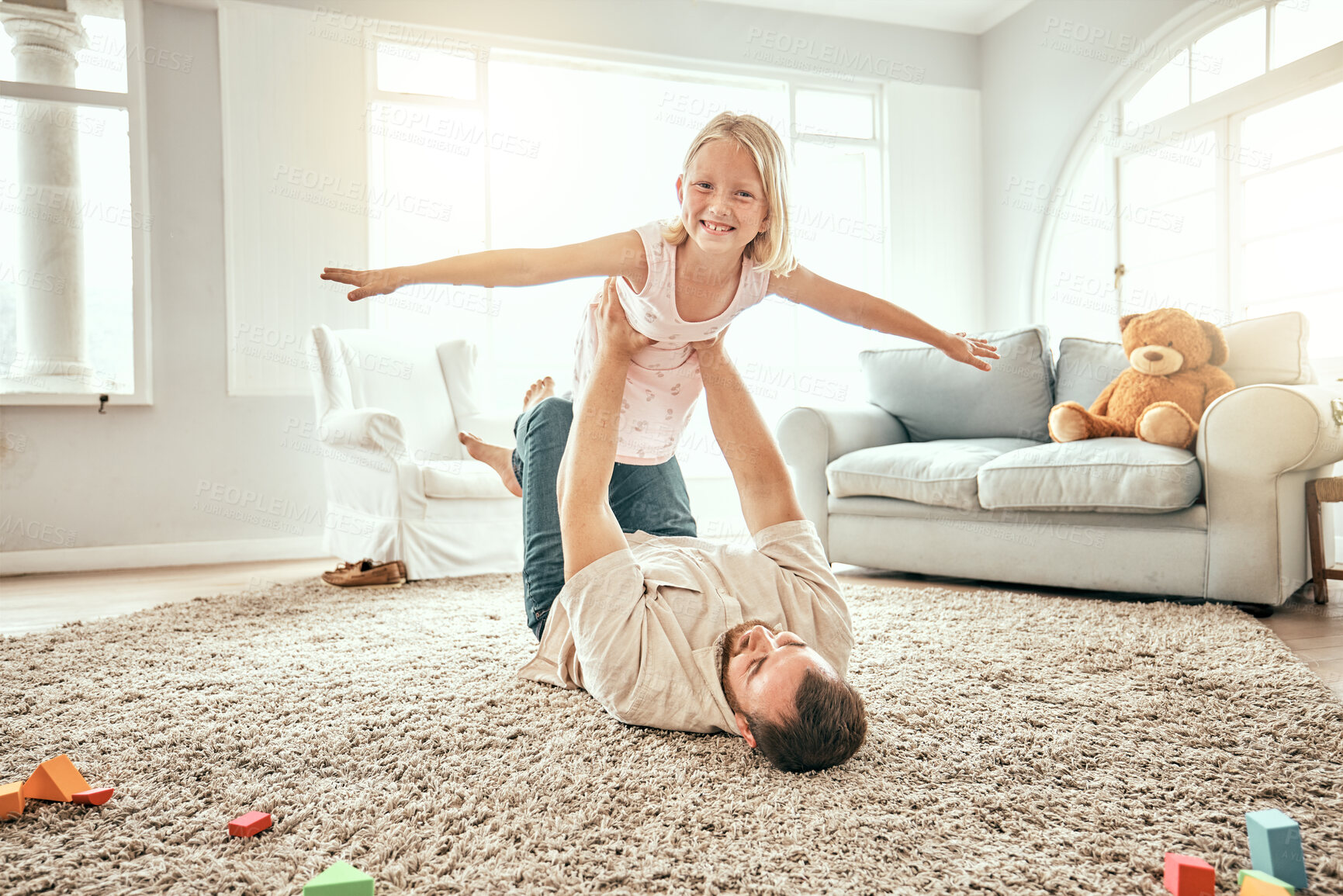 Buy stock photo Flying, portrait and a child with father on the floor for playing, bonding and fantasy in a house. Smile, cute and a dad holding a girl kid for freedom, relax and a game in the living room together