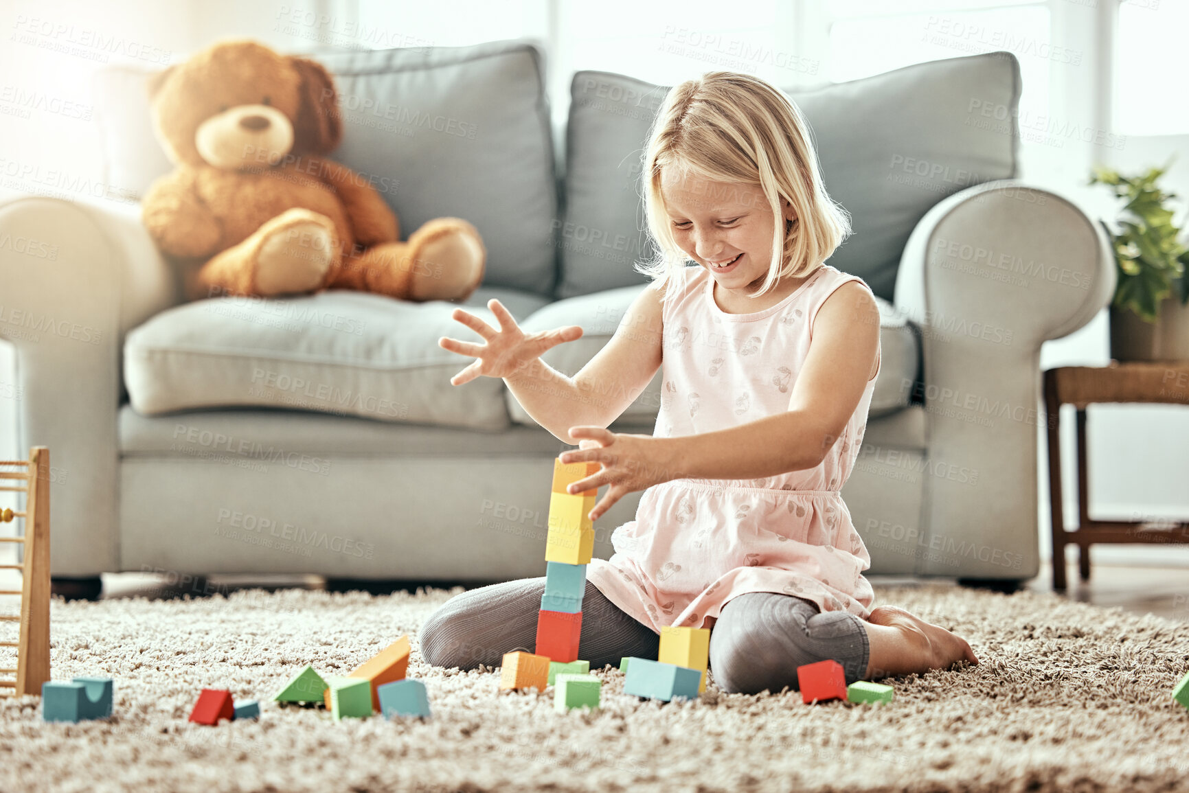 Buy stock photo Kid, playing alone and toys on living room floor, house and educational game, fun and child development. Building blocks, girl and learning for creativity with activity, relax indoors and happiness