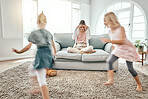 Mother, children and running in living room chaos with headache in stress on sofa at crazy or busy home. Frustrated single parent in burnout with ADHD or hyperactive kids or siblings playing in house