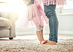 Love, feet and father with girl child in a living room for ballet, learning or dance in their home together. Family time, bond and legs of kid with parent in a house for support, care and security