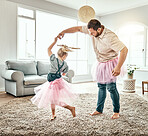 Family, dance or fantasy with a father and daughter together in costume, having fun in the home living room. Love, kids or ballet and a girl child dancing with her man parent on a carpet in the house