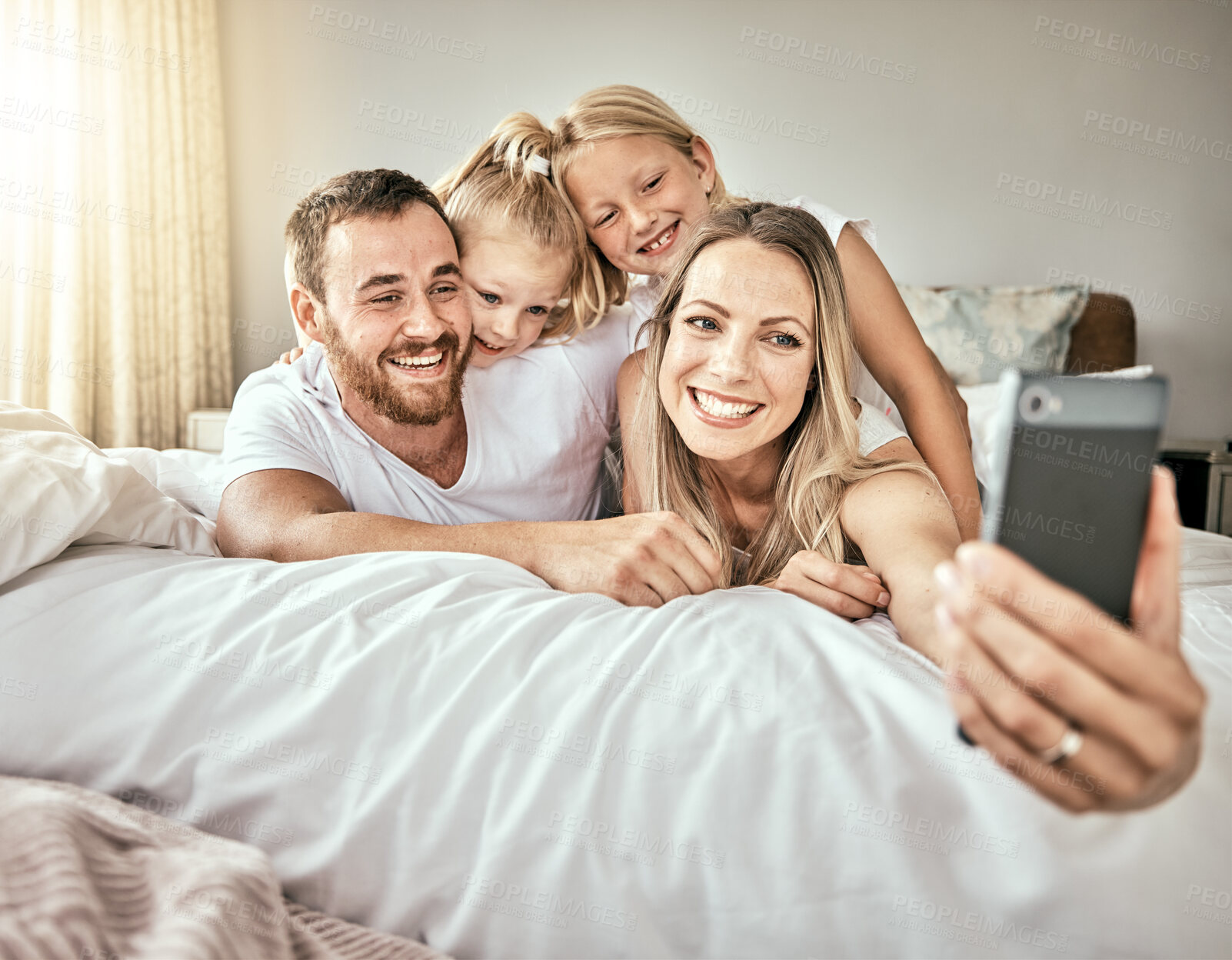 Buy stock photo Selfie, happy and portrait of family on the bed for bonding and relaxing together at modern home. Smile, love and girl children laying and taking a picture with parents from Australia in bedroom.