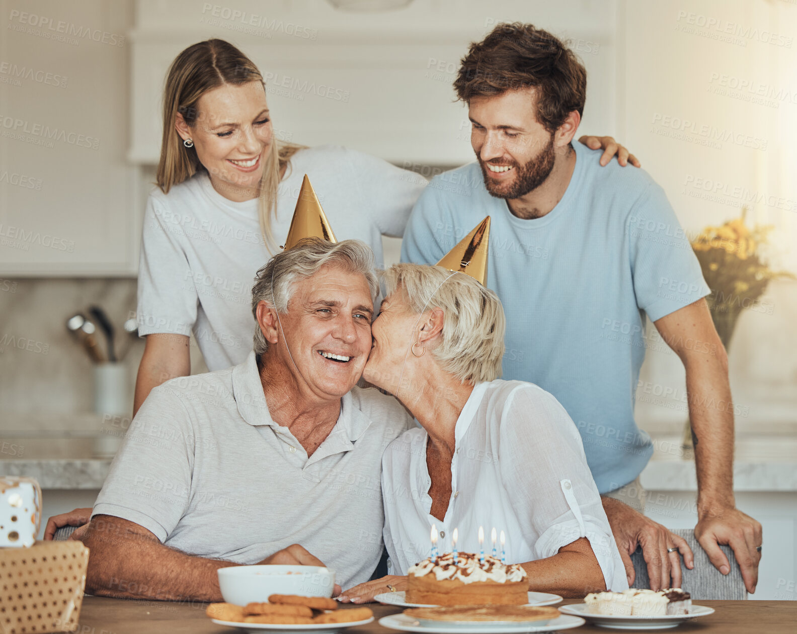 Buy stock photo Happy birthday, kiss and senior parents with cake for party, celebration and festive event in home. Family, smile and elderly mother, father and couple with dessert, decoration and celebrate for love