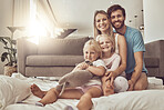 Happy family, portrait and hug on living room floor for weekend, holiday or relax together at home. Mother, father and children smile in happiness for quality time, fun bonding or support in house