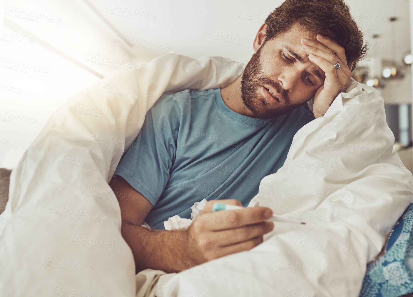 Buy stock photo Thermometer, stress and sick man on a sofa with headache, fever or influenza crisis in his home. Anxiety, high temperature and male person with vertigo, risk or fear of covid infection in living room