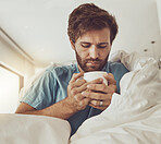 Tea, sick and a man with a blanket on a sofa in the living room of his home for recovery from cold or flu. Coffee, healthcare or lemon and ginger drink in a cup with a young person feeling unwell