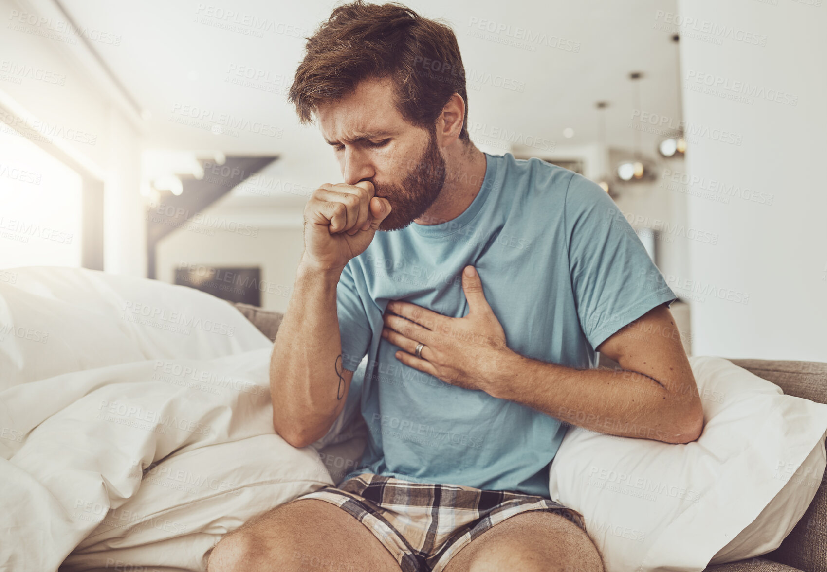 Buy stock photo Sick, coughing and man on a sofa with chest pain, tuberculosis or influenza at home. Asthma, anxiety and male person with breathing trouble in living room with covid, pneumonia or lung virus