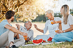 Picnic food, happy family and senior parents, daughter and son having fun, eating grapes and enjoy nature, park or wellness. Fruit, love and relax mature mother, father or garden people bond together