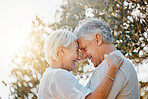 Senior couple, forehead or hug in nature garden for love, support or bonding retirement trust. Woman smile, lens flare or elderly man in embrace for relationship, connection and together in backyard