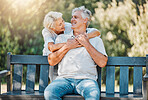 Happy couple, senior and hug on park bench for love, support and bonding together in retirement and nature garden. Smile, relax and elderly woman embrace man in Australia backyard for marriage trust