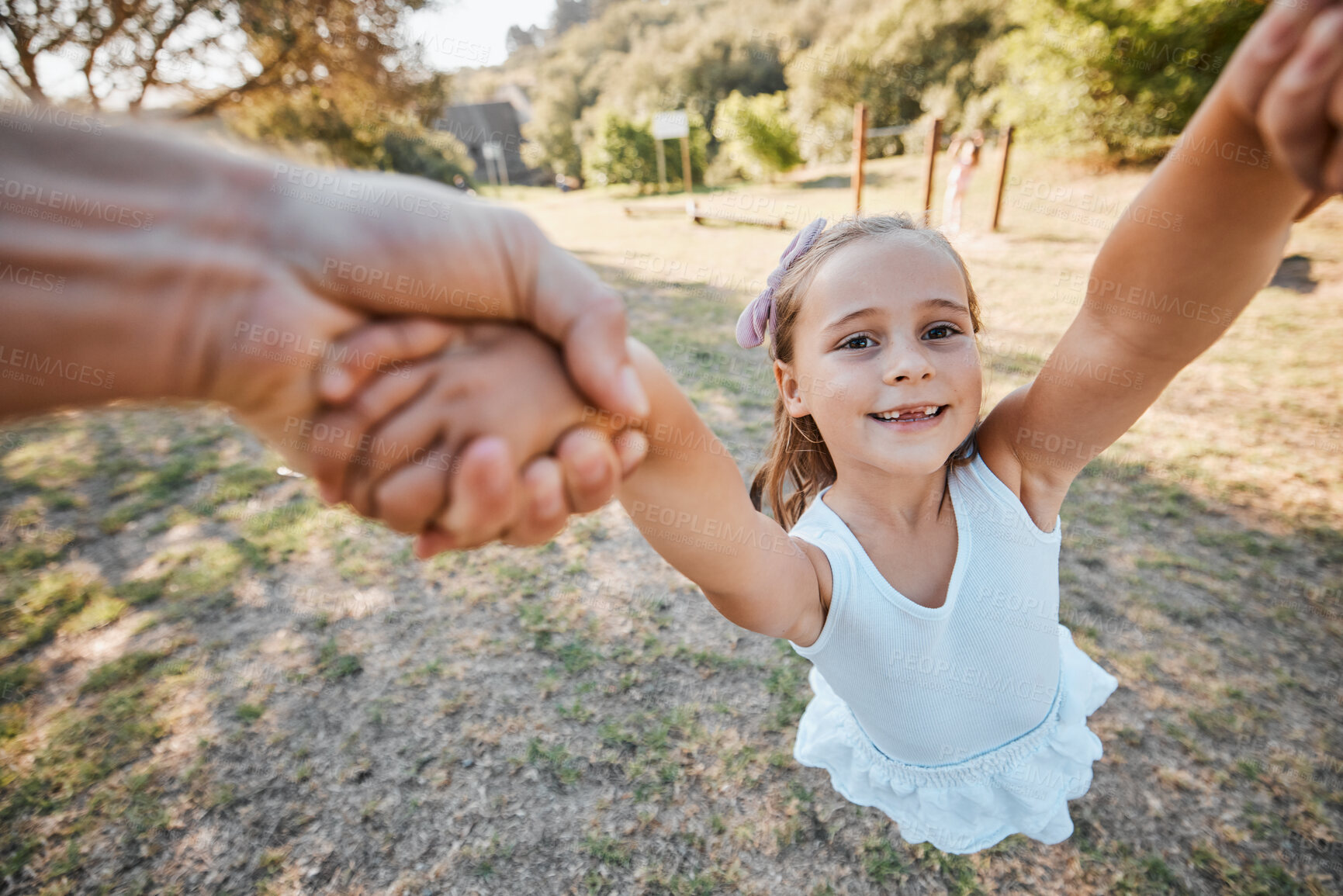 Buy stock photo Happy, pov and hands swing child outdoor in garden, park or game in nature with parent. Girl, face and dad or mom swinging kid for crazy, fun or bonding in summer, vacation or backyard games