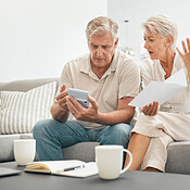 https://photos.peopleimages.com/picture/202310/2845858-frustrated-senior-couple-documents-and-financial-crisis-on-living-room-sofa-in-debt-expenses-or-bills-at-home.-mature-man-and-woman-checking-finance-paperwork-or-budget-with-calculator-for-invoice-box_175_175.jpg