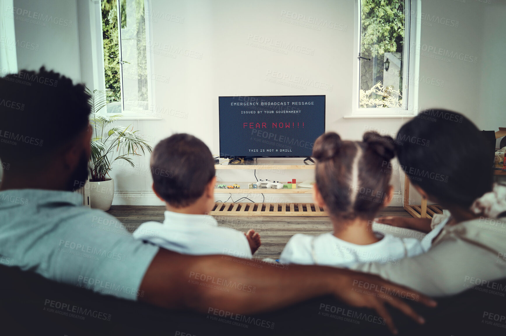 Buy stock photo Back, family and watching tv for government announcement with people in their home during an emergency broadcast. Mother, father and children in the living room for fear propaganda in a disaster