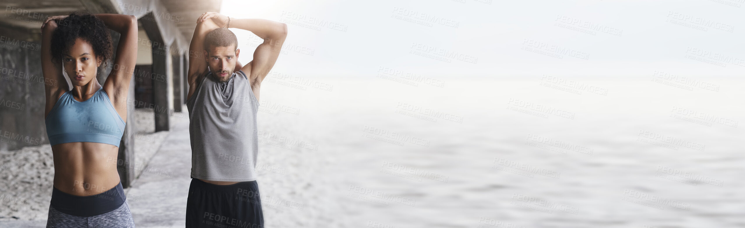 Buy stock photo Body, stretching and fitness couple at a beach with mockup for training, wellness and cardio routine together. Arm, stretch and sport people at the ocean for running, exercise or resilience practice