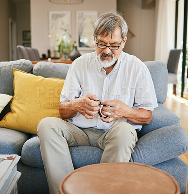 Buy stock photo Home, wrist watch and senior man on sofa to repair, fix wristband and set alarm in living room. Retirement, house and elderly person sitting on couch check clock for time, countdown and timer