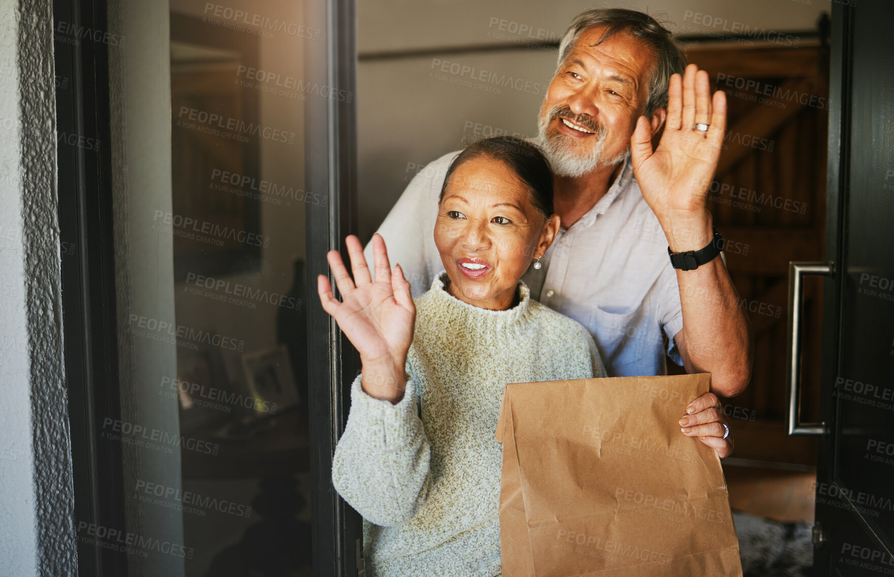 Buy stock photo Mature couple, wave and delivery of package in home, commerce or cargo service at door. Asian man, happy woman and goodbye hand sign for communication, thank you for shipping parcel or smile together